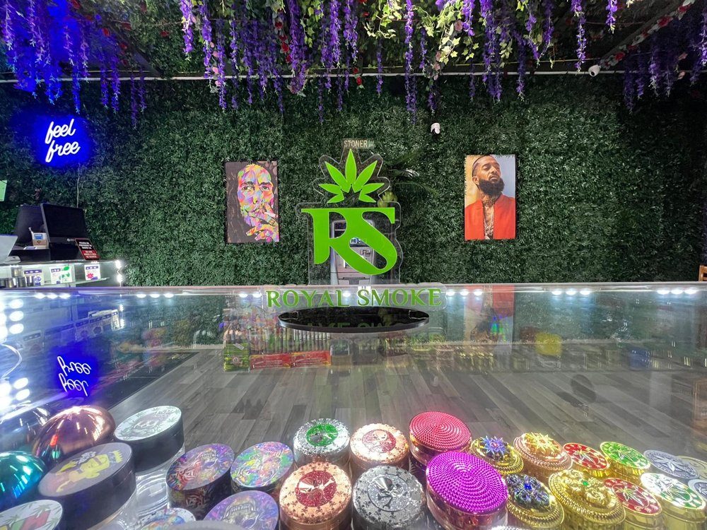 Inside Royal Smoke — display counters and the RS neon wall